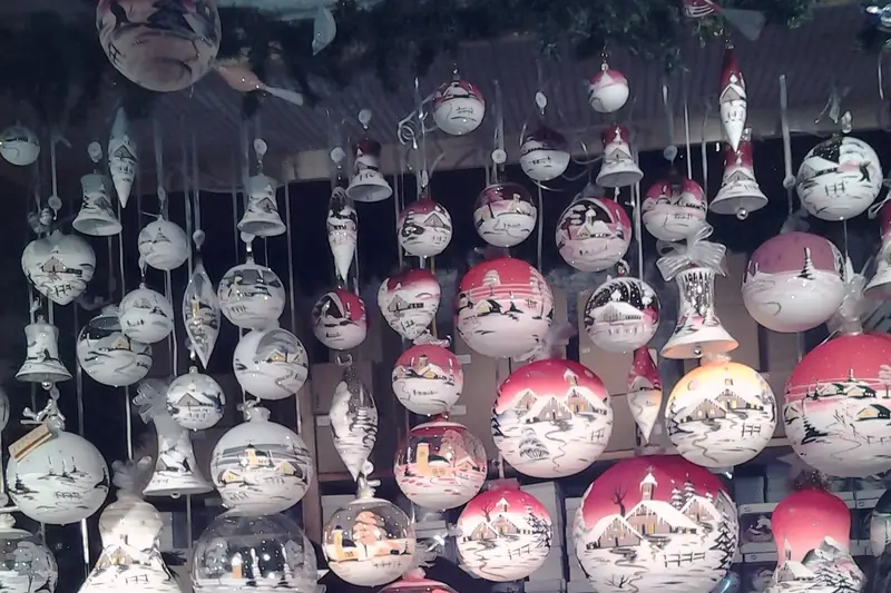Glass holiday ornaments hanging at a German Christmas market stall in Chicago